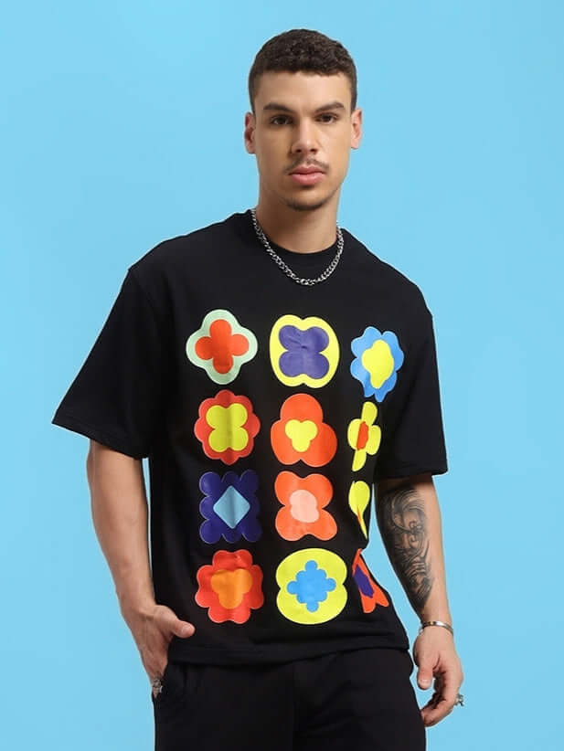 Model wearing Hollister oversized black T-shirt with colorful geometric patterns, made of premium cotton blend, ideal for casual wear.