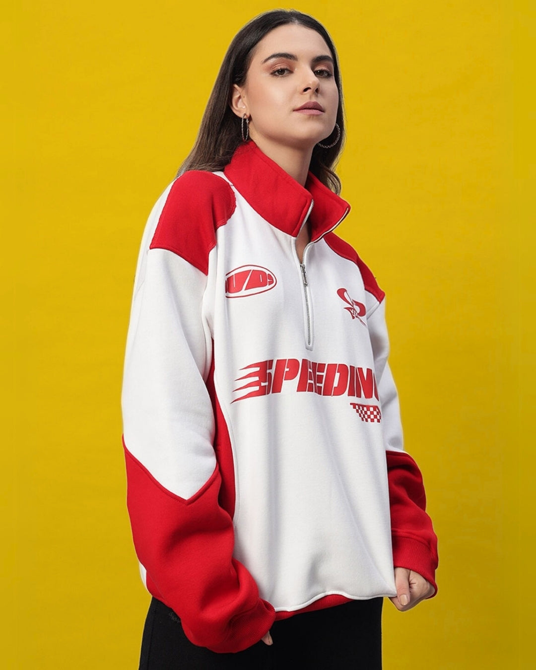 Woman wearing women's speeding red colorblock jacket with zip collar, showcasing modern design and bold style.