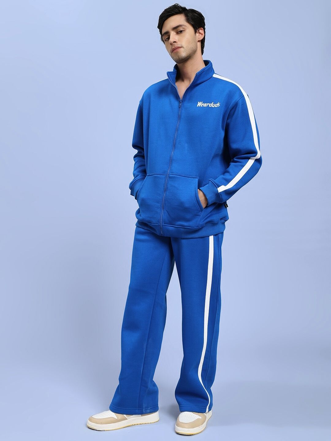 Model wearing RAPID STRIDE ROYAL BLUE COTTON FLEECE CO-ORD SET with zip-up jacket and pants, showcasing a vibrant activewear look.