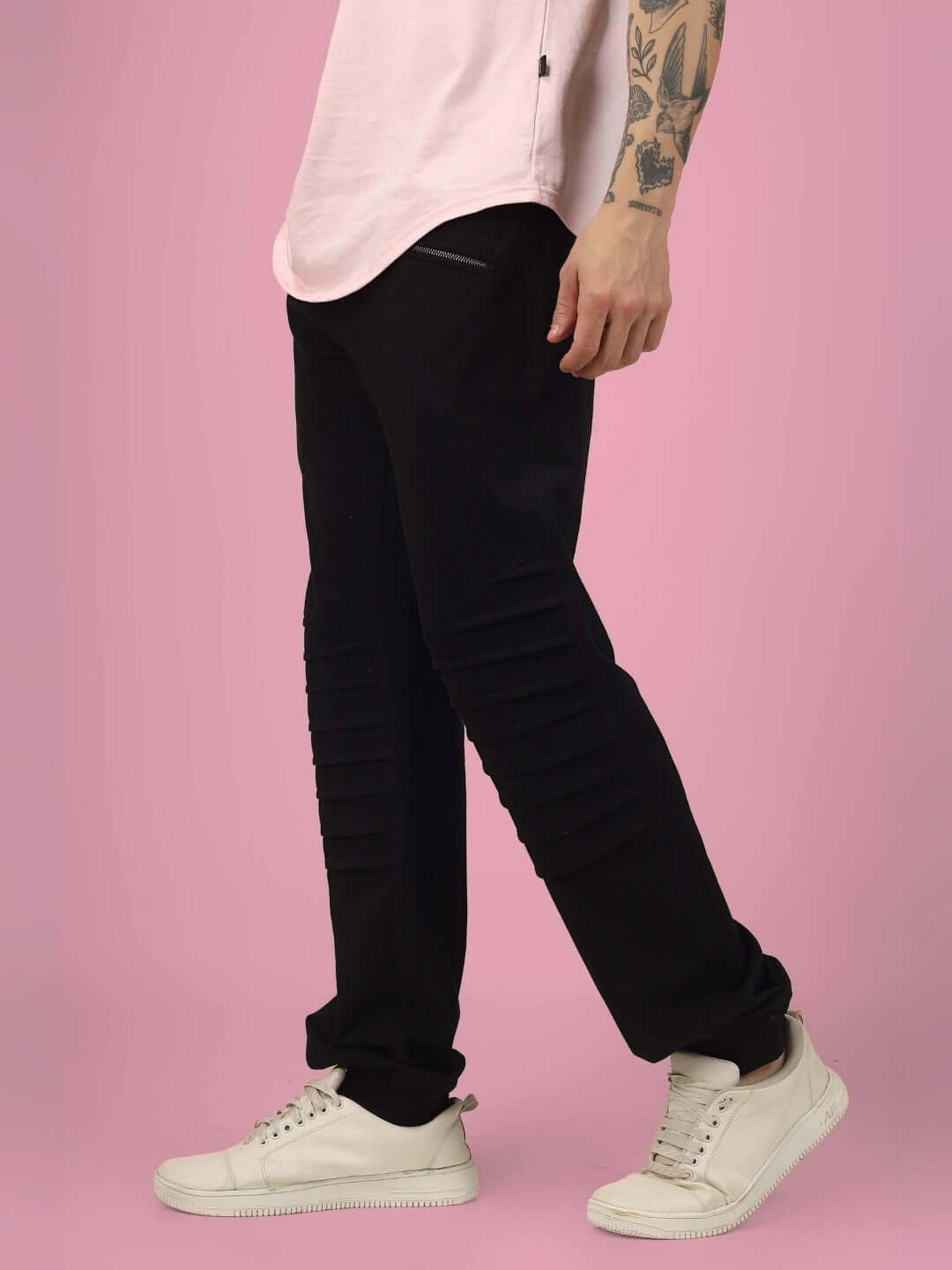 Man wearing 2 ZIPPER POCKET COTTON JOGGER BLACK with casual sneakers on pink background