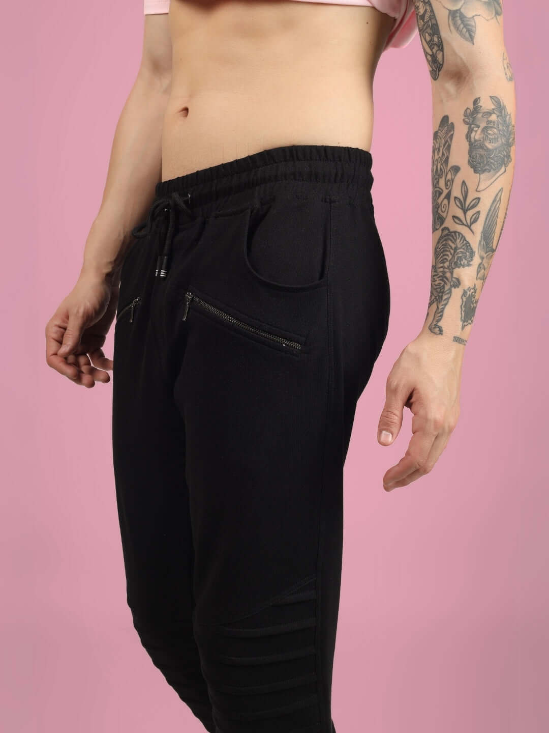 2 ZIPPER POCKET COTTON JOGGER BLACK shown in side profile with a focus on the sleek silhouette and zipper details.
