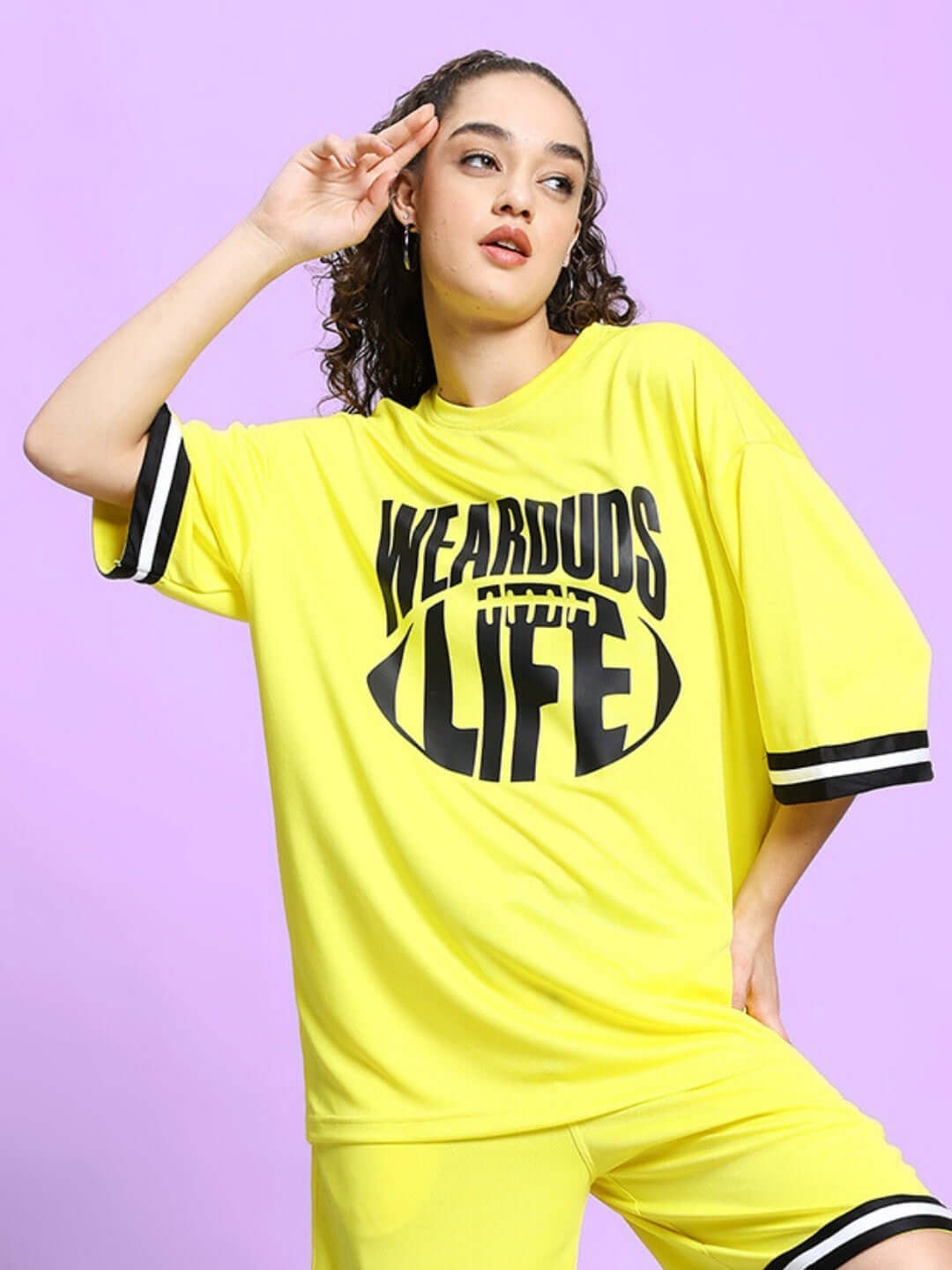 Model wearing yellow oversized Vigor T-shirt with bold print, suitable for custom fit options.