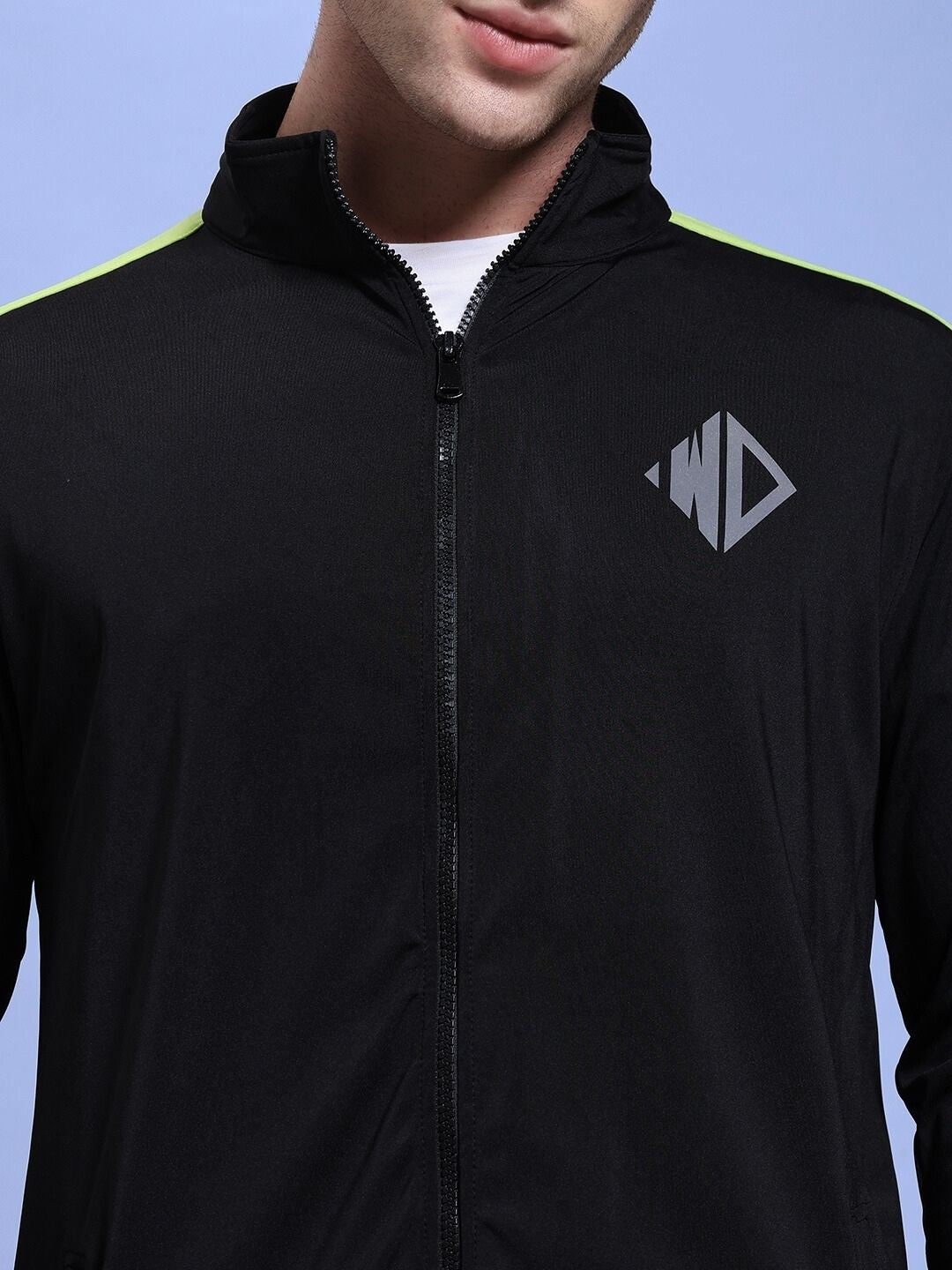 Model wearing HIGH PERFORMANCE CO-ORD SET BLACK featuring a zip-up hoodie with logo detail, ideal for workouts and casual wear.