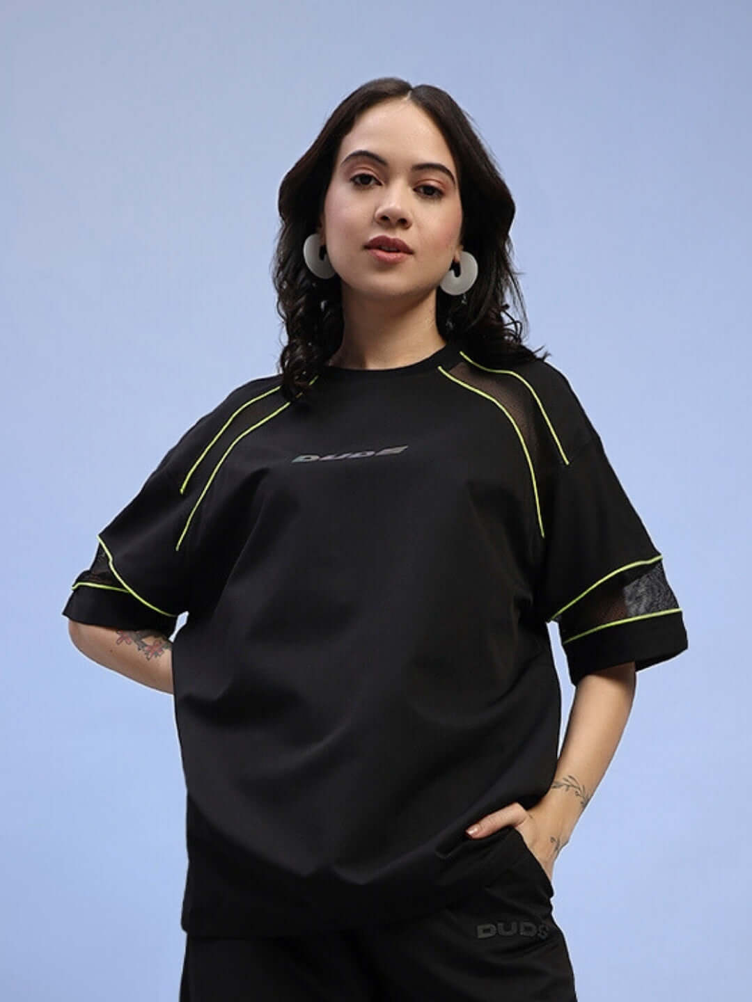 Woman wearing a black women's salvo regular fit t-shirt with neon accents, made of sports polyester fabric; ideal for casual wear.