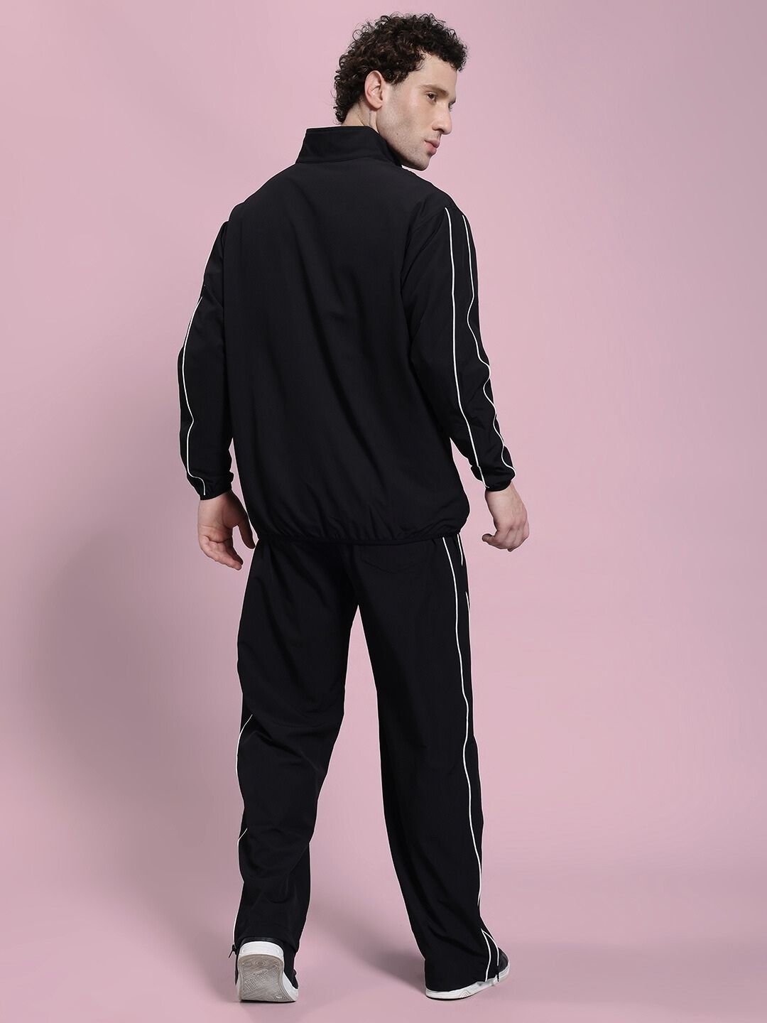 Back view of model wearing RELIGHT RELAXED FIT CO-ORD SET BLACK, showcasing oversized hoodie and tapered pants.