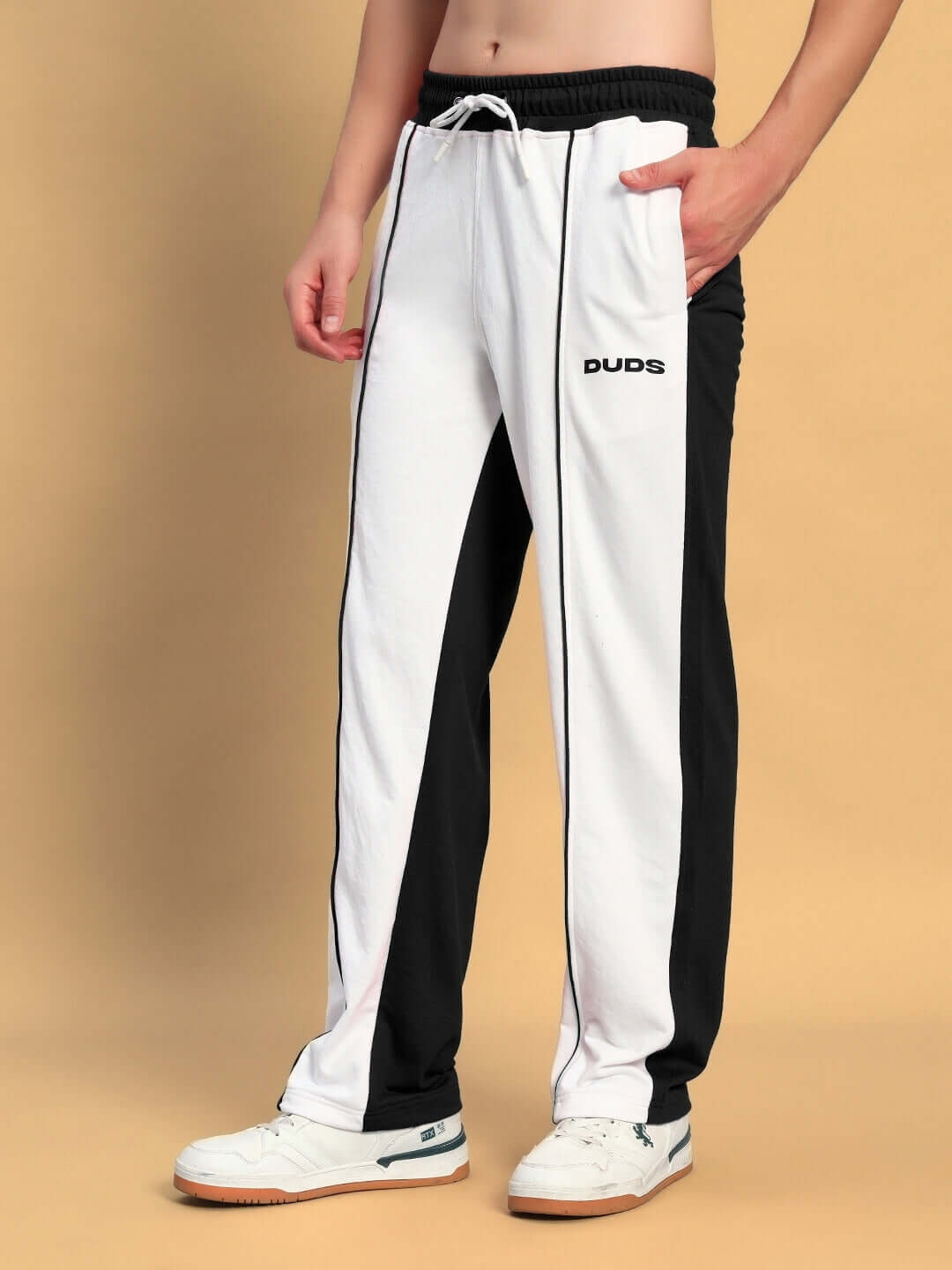 Model wearing Lagoon Relaxed Fit Joggers in white and black by DUDS; made-to-order casual wear with customizable fit options.
