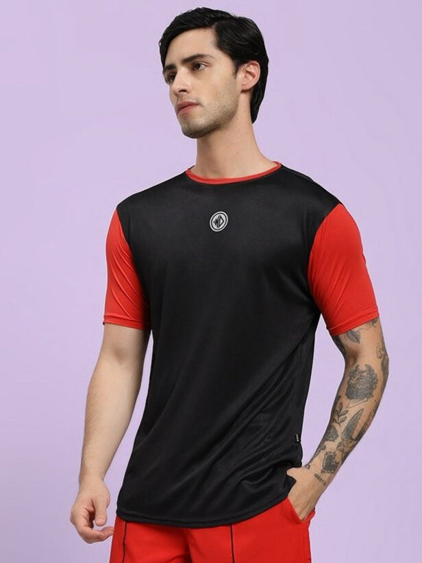 Man wearing a black and red sports outfit on a light purple background