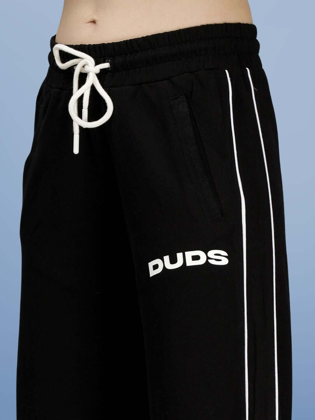 Close-up of WOMEN RIO RELAXED FIT JOGGERS BLACK with drawstring and side stripes, showcasing comfort and style.