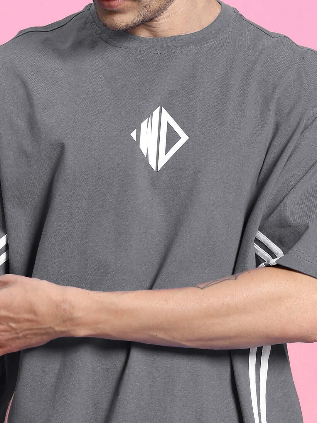 Model wearing Outlook over-sized grey t-shirt, made of premium cotton French terry, featuring logo design on the front.