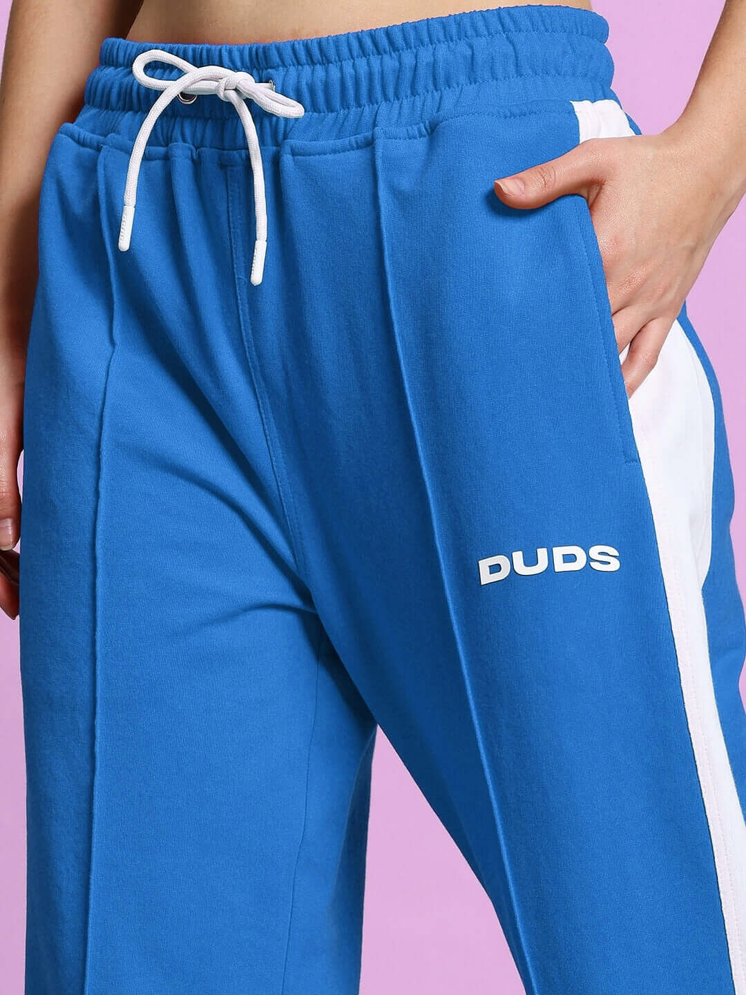 Close-up of Women's Wonder Slit Zipper Joggers in blue-white by DUDS, showcasing elastic waistband and side stripes.