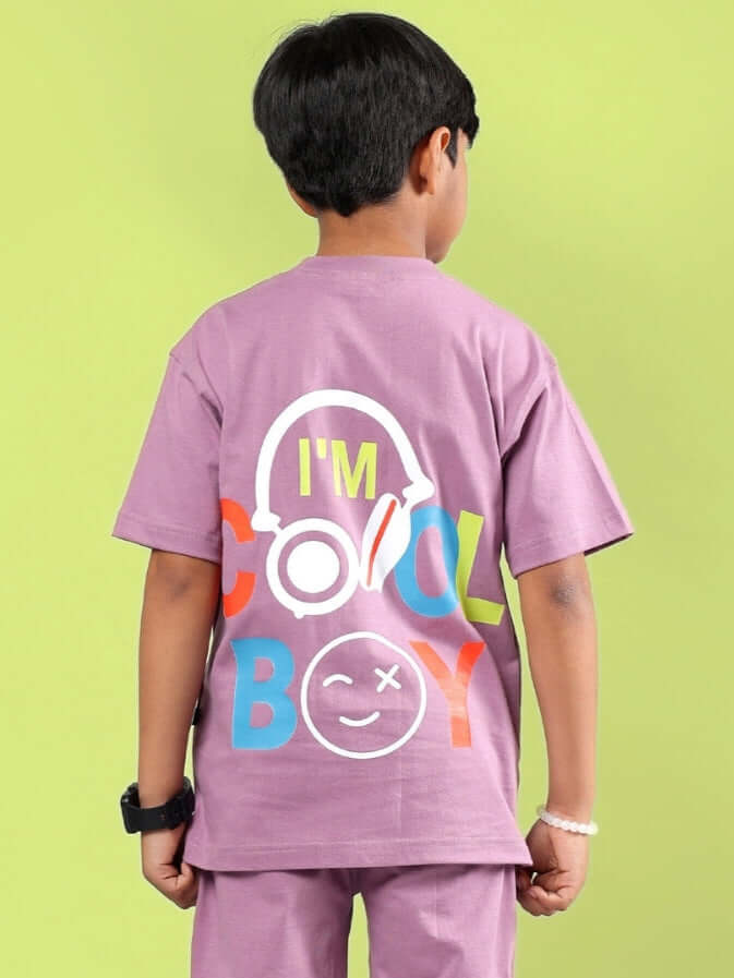 Young boy wearing a STOIC purple t-shirt with 'I'm Cool Boy' print, styled with fun graphics, perfect for boys and girls. Made by DUDS.