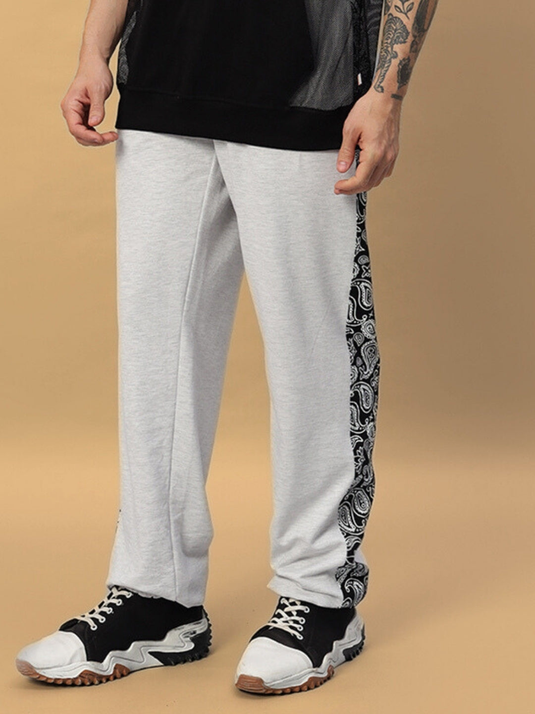Model wearing Boogie Relaxed Fit Joggers in Melange Grey with patterned side, made to order by DUDS Tailors.