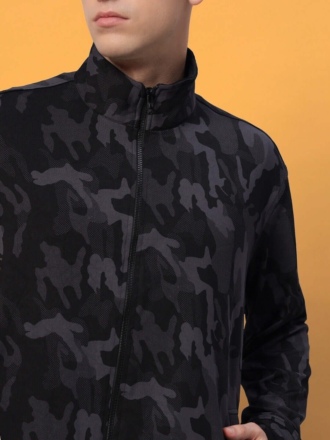 Man wearing a DEFENCE camouflage jacket in navy camo pattern with a front zipper, made to order by DUDS.