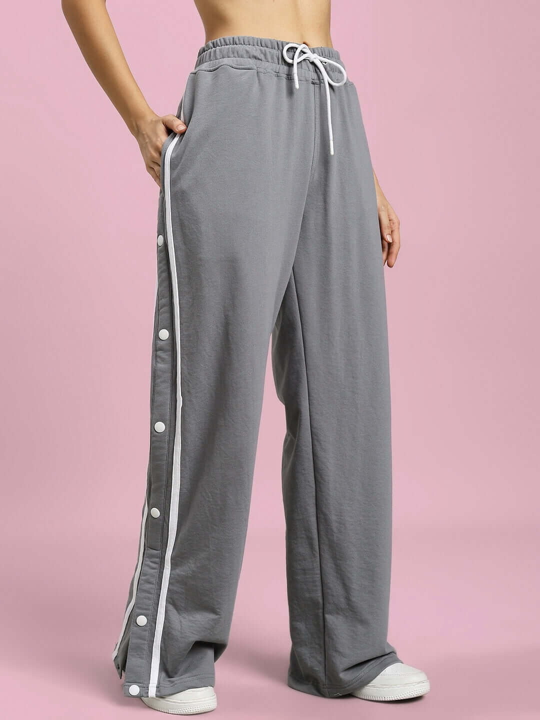 Women's grey jogger with white contrast panels and button accents, perfect for casual wear. Made to order by experienced tailors at DUDS.