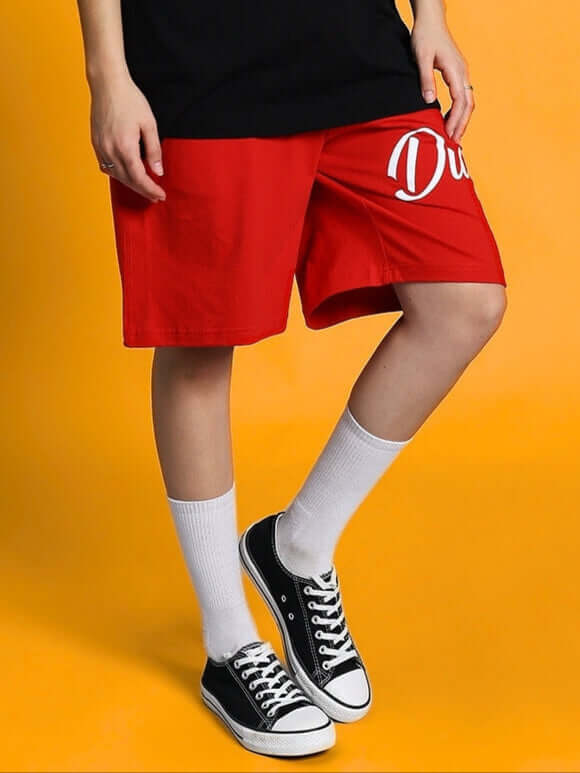 Women's Columbia 22 regular fit red shorts with customizable size option, styled with white socks and black sneakers.