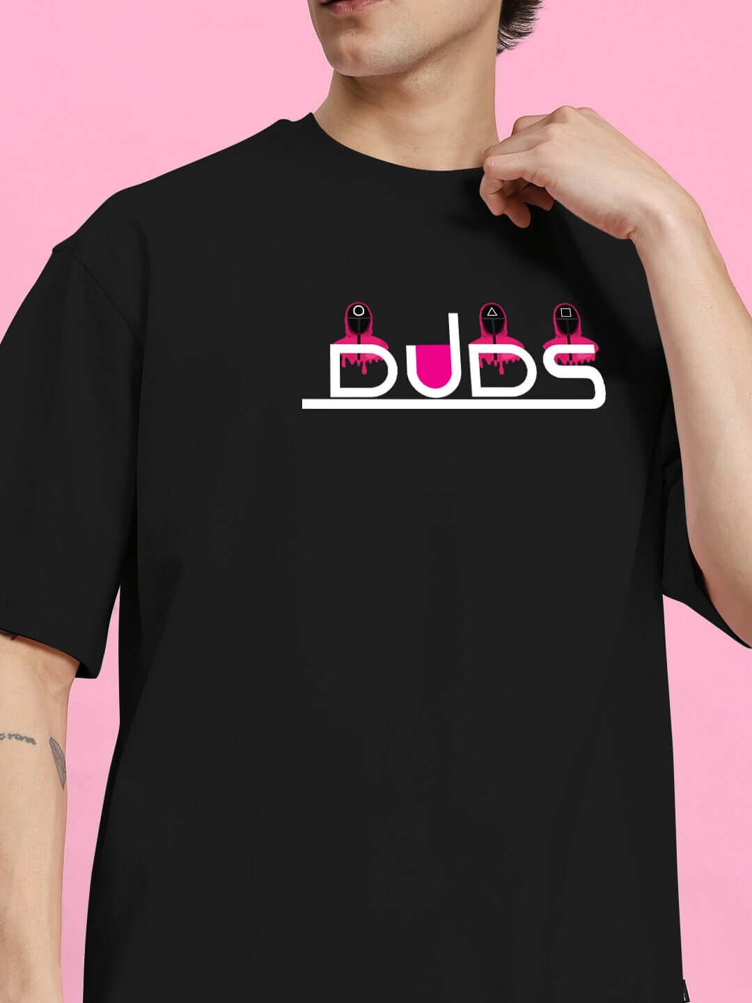 Black Squid Game printed oversized t-shirt made of 100% cotton, modeled against a pink background. Premium quality, 200 GSM bio-washed.