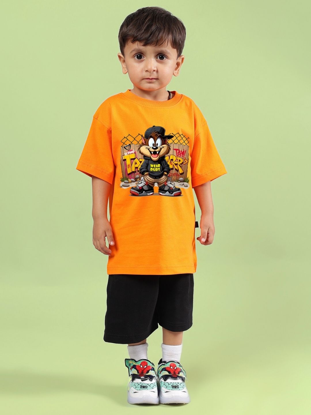 Child wearing Crazy Rapper co-ord set in orange and black, featuring street-style design for boys and girls, with colorful graphic t-shirt.