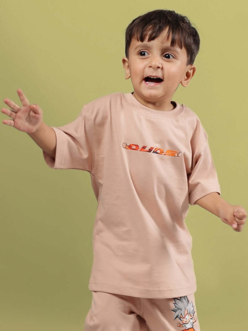 Child wearing a beige Gohan t-shirt for boys and girls by DUDS, against a green background.