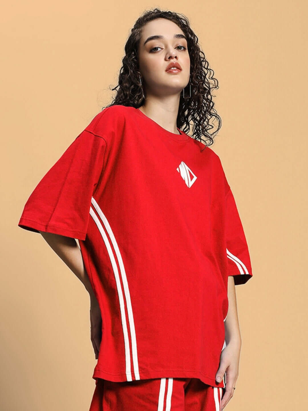 Woman wearing a red oversized T-shirt with white stripes, crafted from premium cotton fabric, by Color By Colours.