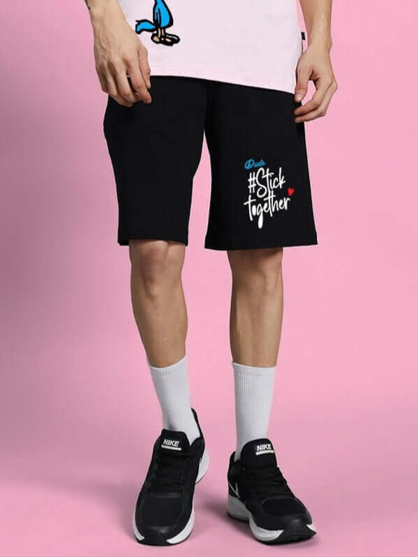COOL PALS regular fit black shorts with #StickTogether design, customizable size option, worn with white socks and black sneakers.