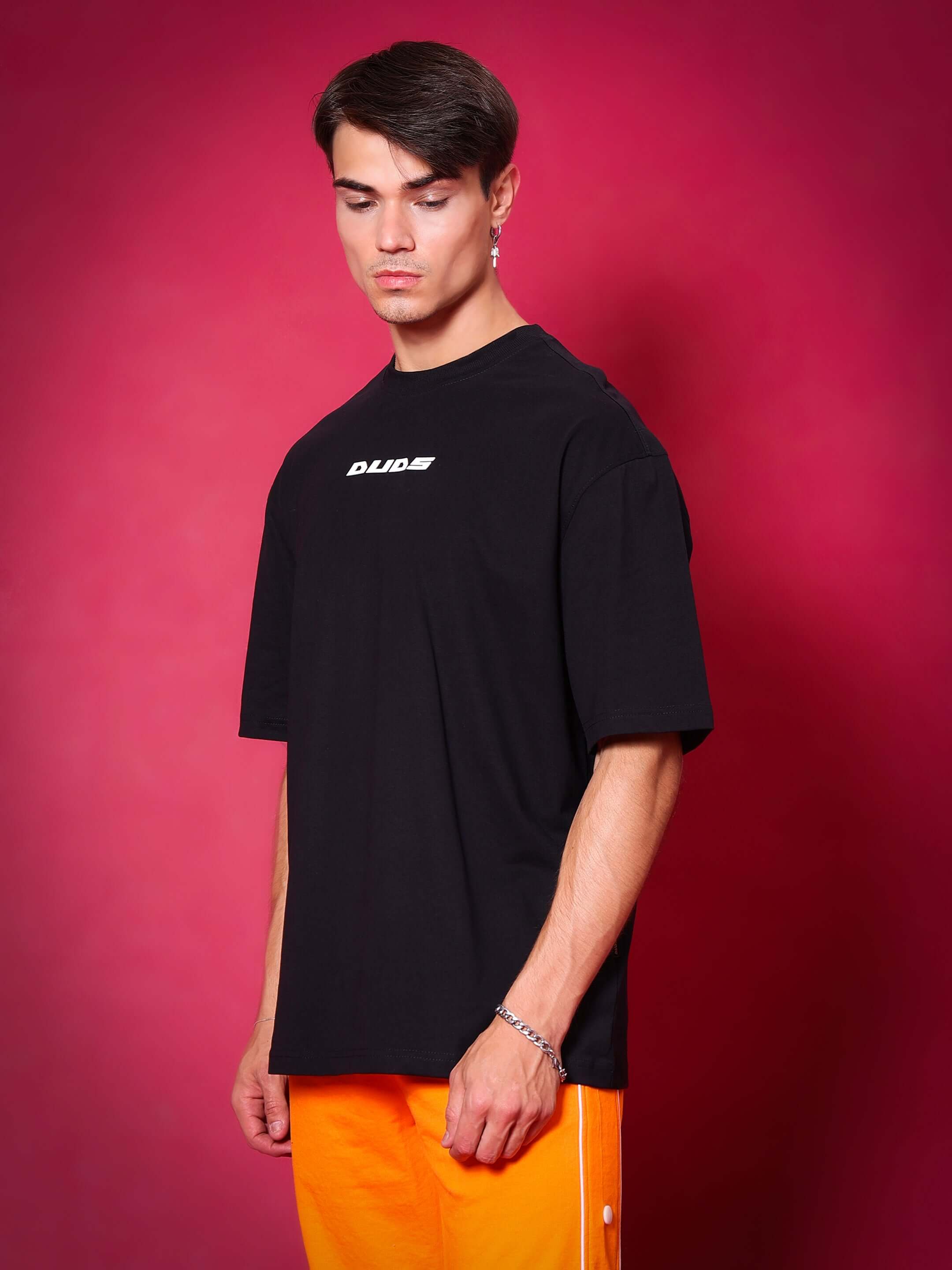 Man wearing GLITTERED HD MOON OVER-SIZED T-SHIRT BLACK, showcasing bold streetwear style with vivid graphic and oversized fit.