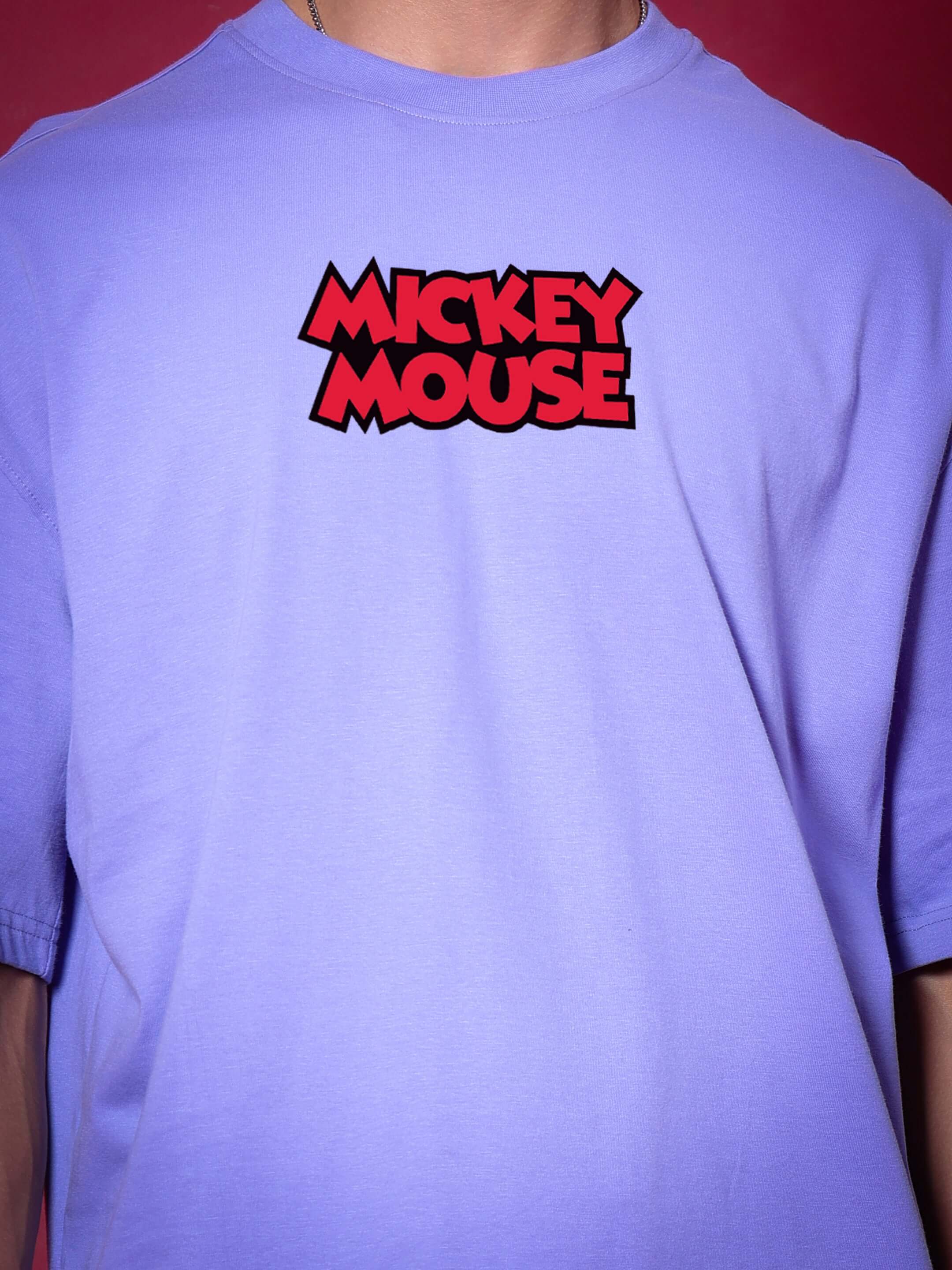 Person wearing DUDS MOUSE OVER-SIZED T-SHIRT PERIWINKLE with Mickey Mouse graphic on periwinkle fabric.