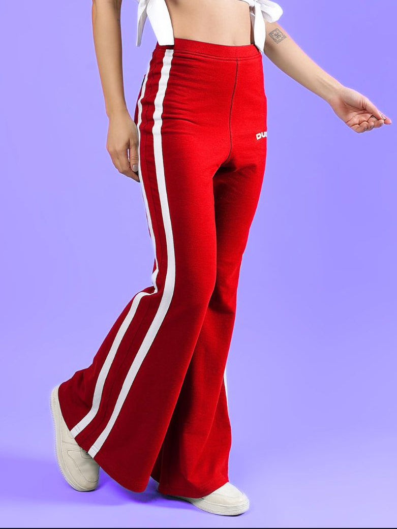 WOMENS FITTONIA COOL WIDE FLARE JOGGERS RED displayed on a model, featuring a stylish wide-flare silhouette.