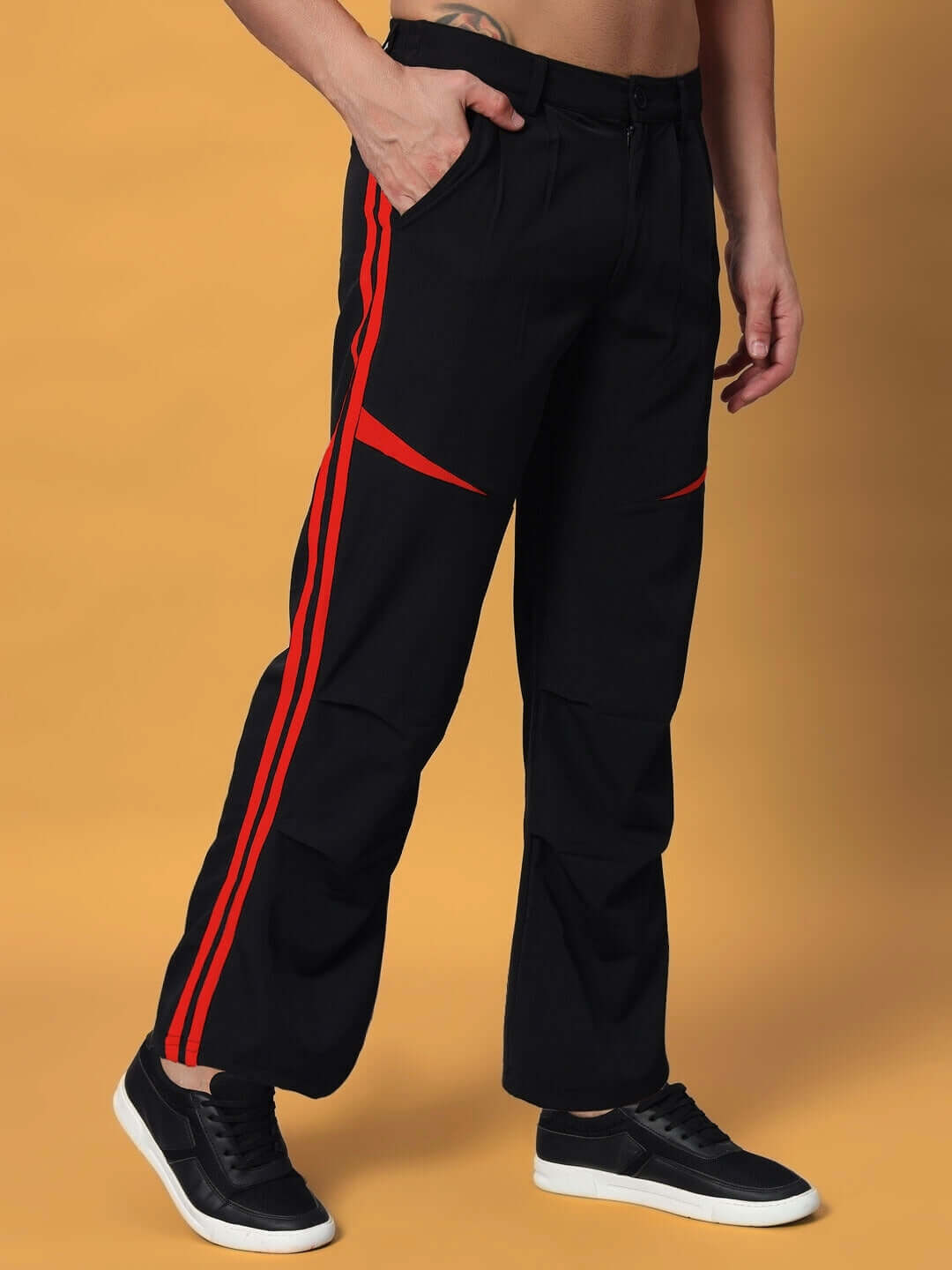 DROVE relaxed fit black cargo pants with red accents, customizable size option available, worn with black sneakers on a beige backdrop.