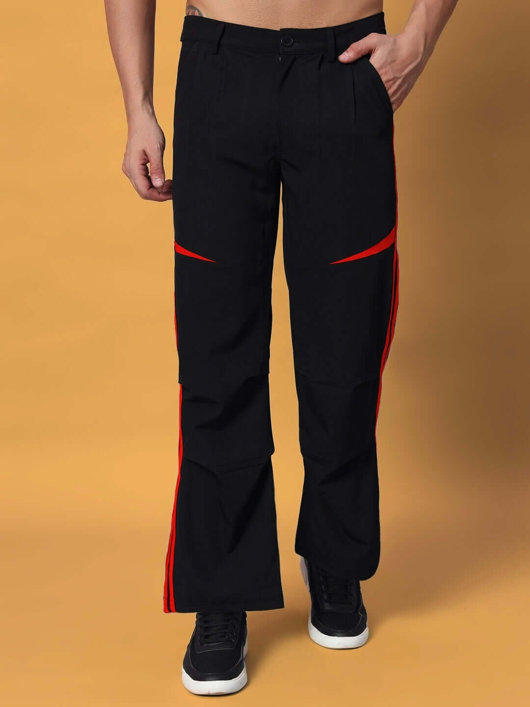 Black cargo pants with red accents, displayed on a model. Relaxed fit and customizable sizes available with prepaid orders.