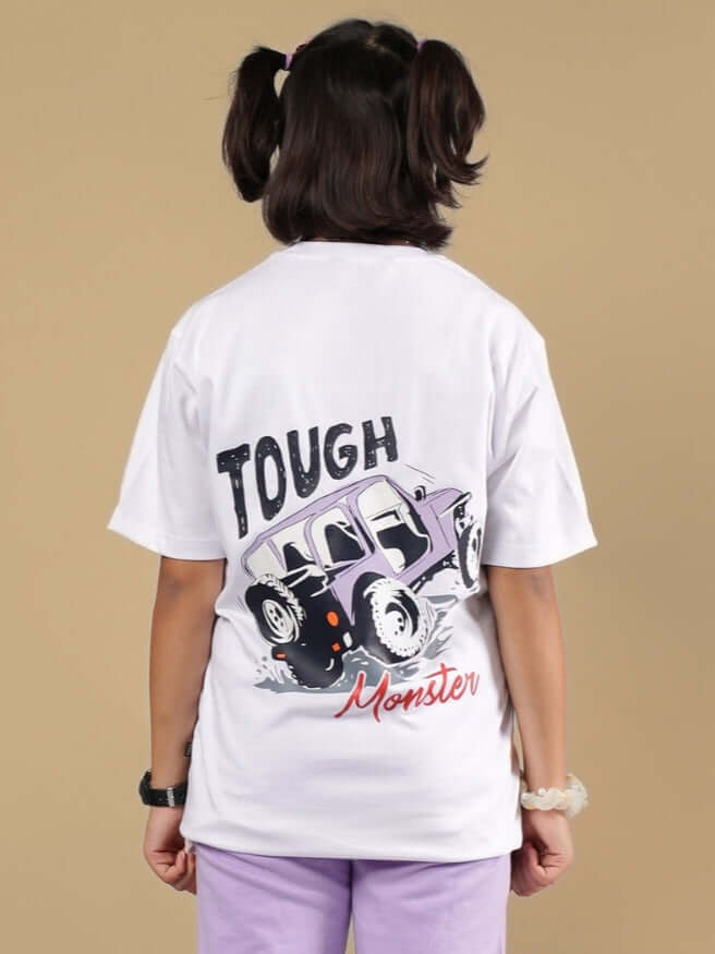 Child wearing a white 'Tough Monster' graphic t-shirt with a purple monster truck design.