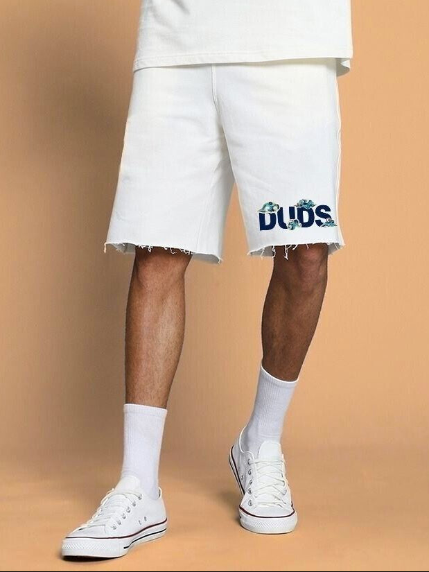 Man wearing CLOUD PRINTED RELAXED FIT SHORTS OFF WHITE, featuring a cloud design, perfect for casual style, with white sneakers.