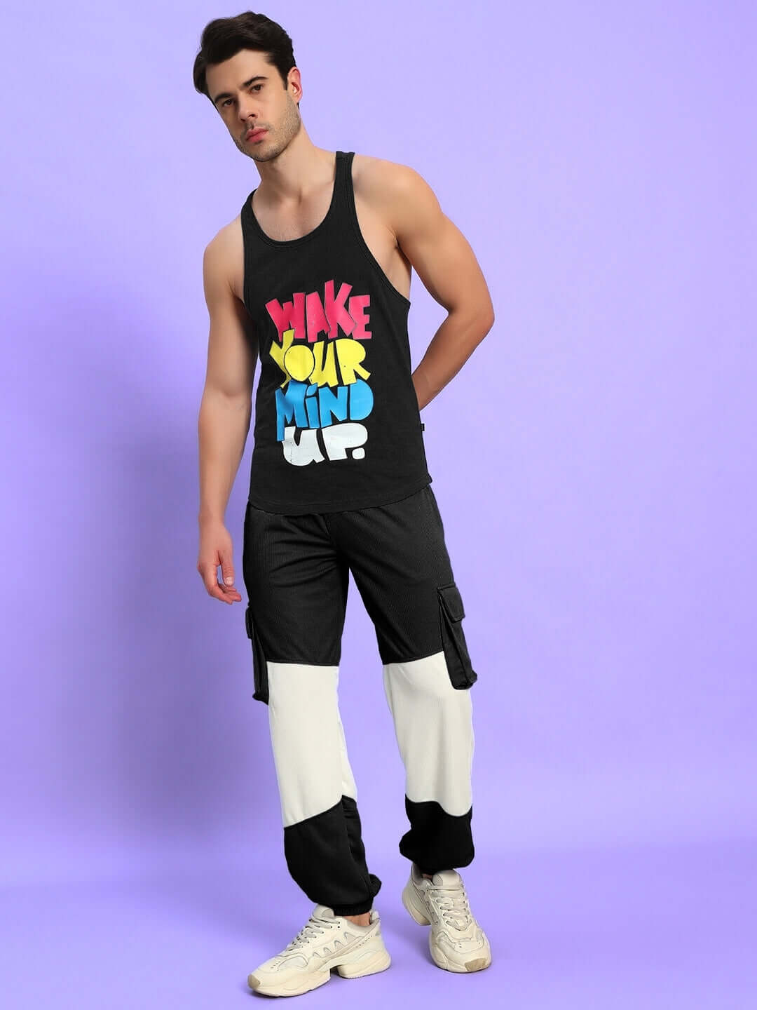 Person wearing Radiant Relaxed Fit Joggers in black and white, standing on a purple background, showcasing comfortable casual wear.