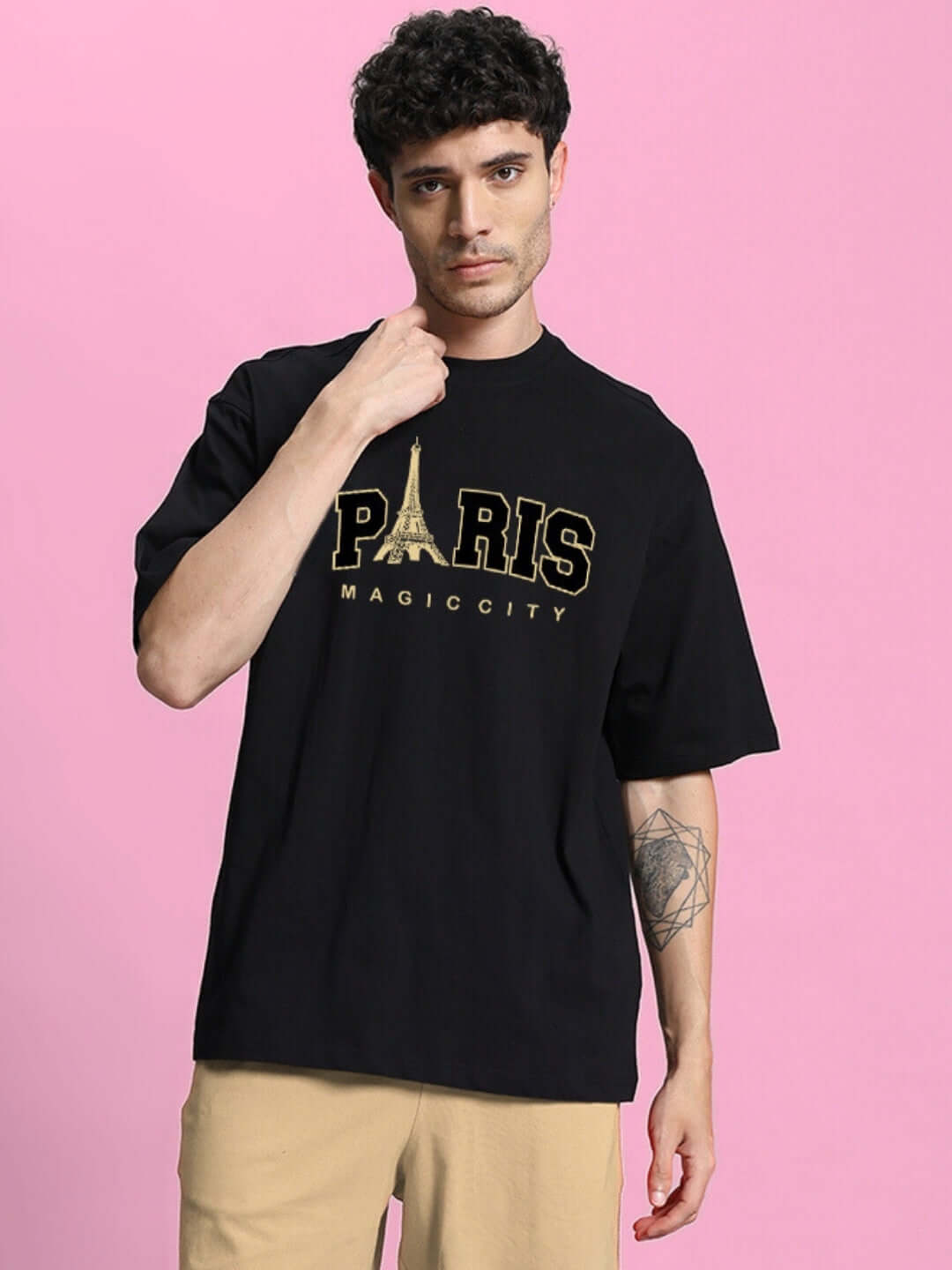 Model wearing MAGIC CITY Oversized Black T-Shirt with Paris Eiffel Tower design, crafted from premium 200 GSM cotton. Fashionable urban style.