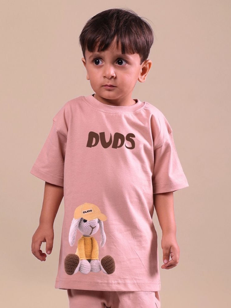 Child wearing a beige Flint Bunny T-shirt with bunny graphics, designed for boys and girls.