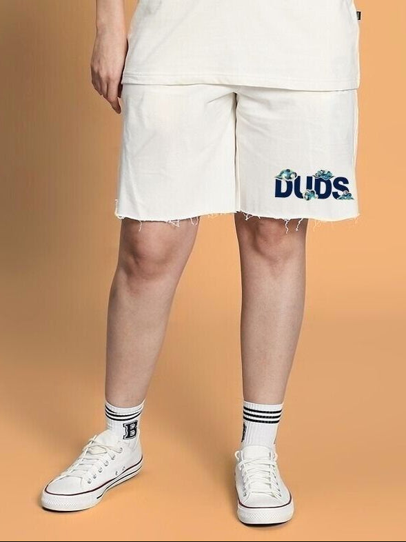 WOMEN CLOUD PRINTED RELAXED FIT SHORTS OFF WHITE worn by model with sneakers, showcasing casual style.