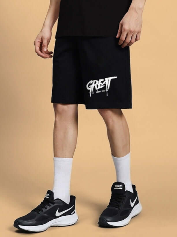 Model wearing black summer shorts with 'GREAT' print, showcasing comfortable fit; available with a customizable size option for prepaid orders.