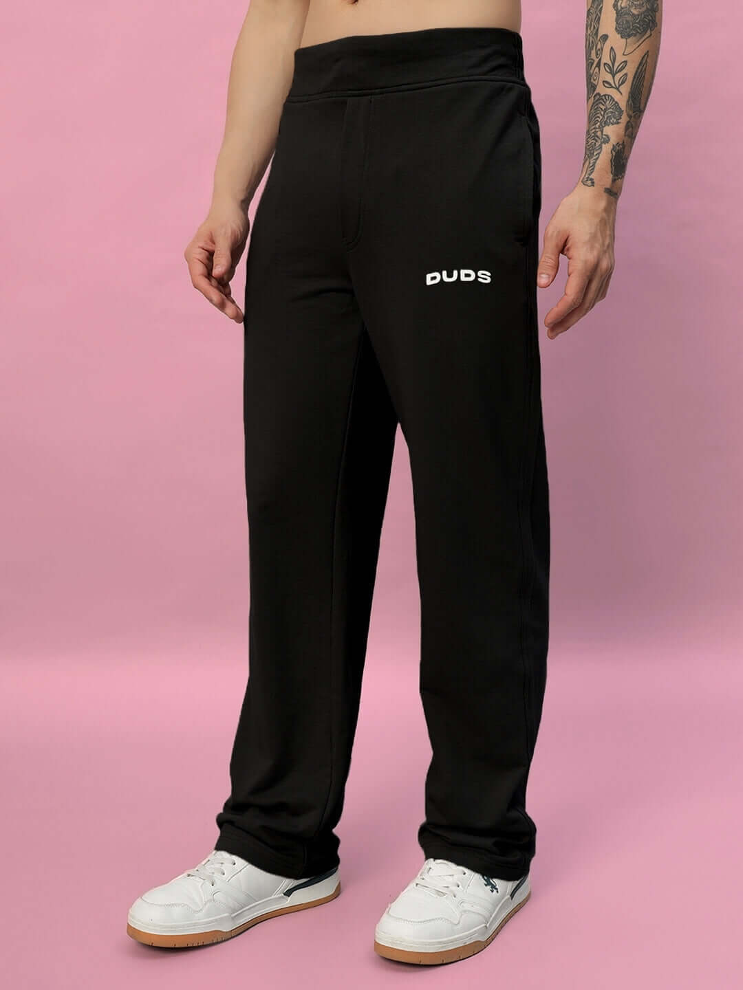 Model wearing black New Era Relaxed Fit Joggers by DUDS, showcasing comfortable and customizable fit options.
