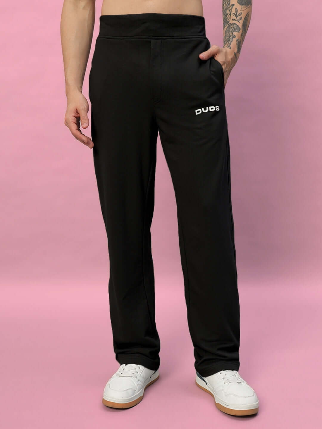 Black NEW ERA Relaxed Fit Joggers by DUDS worn by model, showcasing comfortable design; customizable fit options available.