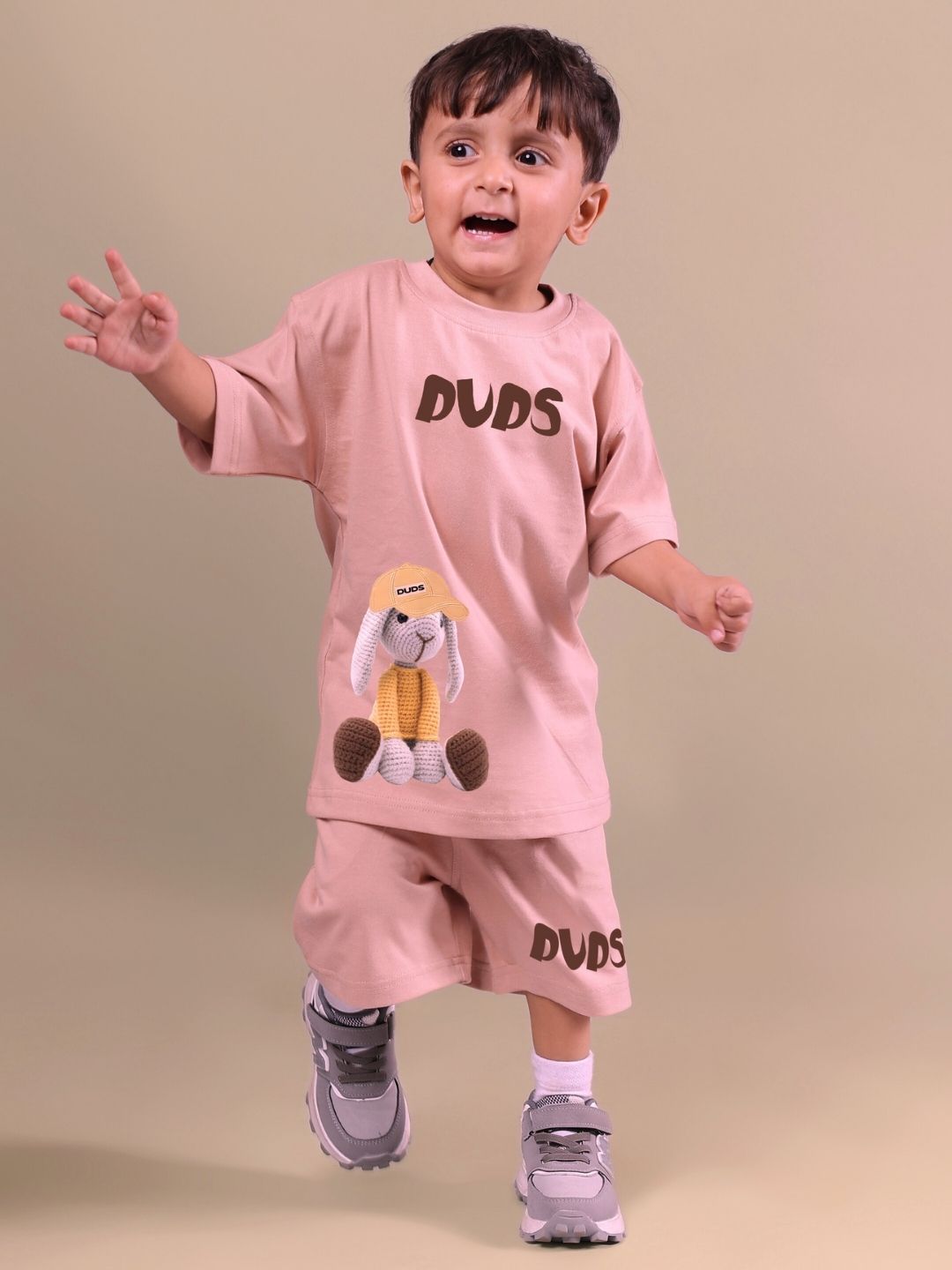 Child wearing beige Flint Bunny co-ord set with bunny details, perfect for boys and girls, showcasing playful design and comfort.