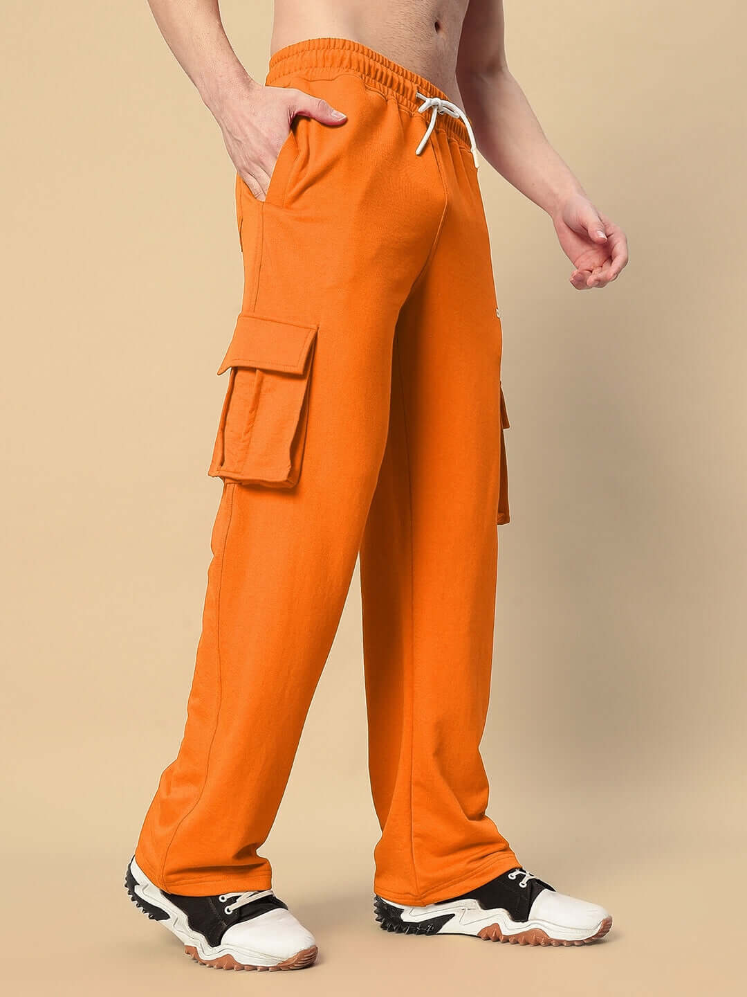 Model wearing orange JESS 5 Pocket Relaxed Fit Joggers from DUDS, showcasing casual comfort and functional design with side pockets.