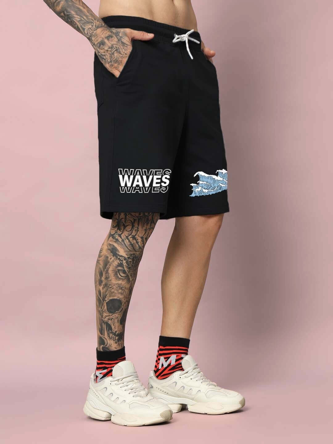 Person wearing black 3D Waves Regular Fit Shorts with bold wave design, showcasing comfort and style for casual outings.