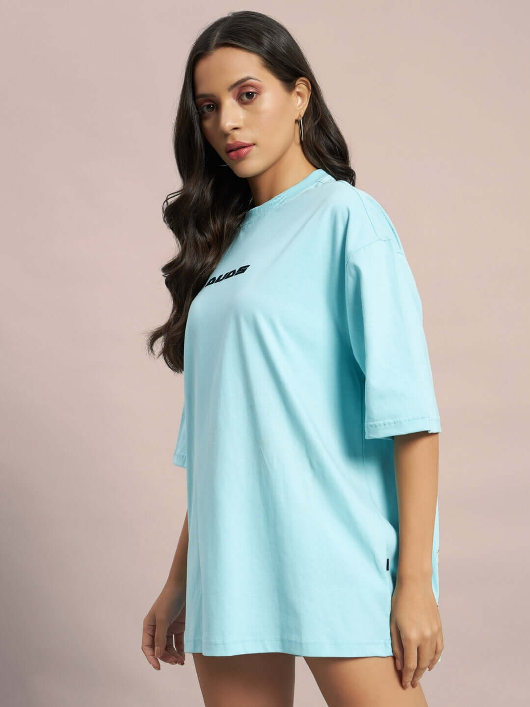 Model wearing a women's oversized sky blue t-shirt with 'Ethereal Creatures' design, ideal for a casual and stylish look.