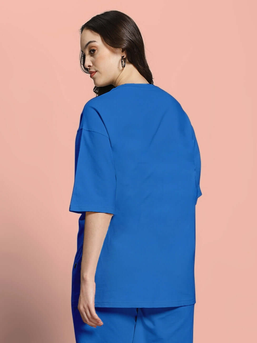 Woman wearing a blue oversized t-shirt made from premium heavy gauge fabric with French terry cotton, showcasing the back view.