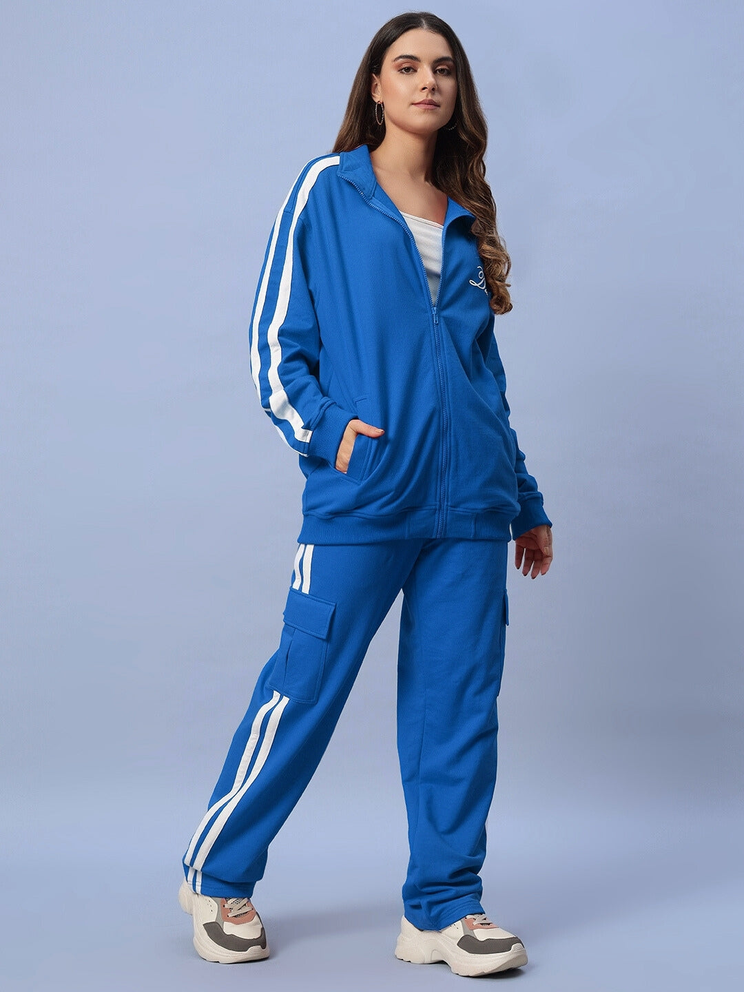 Model wearing Women's Scotia Co-ord Set in royal blue, showcasing a sporty jacket and pants made of 100% cotton terry fabric.