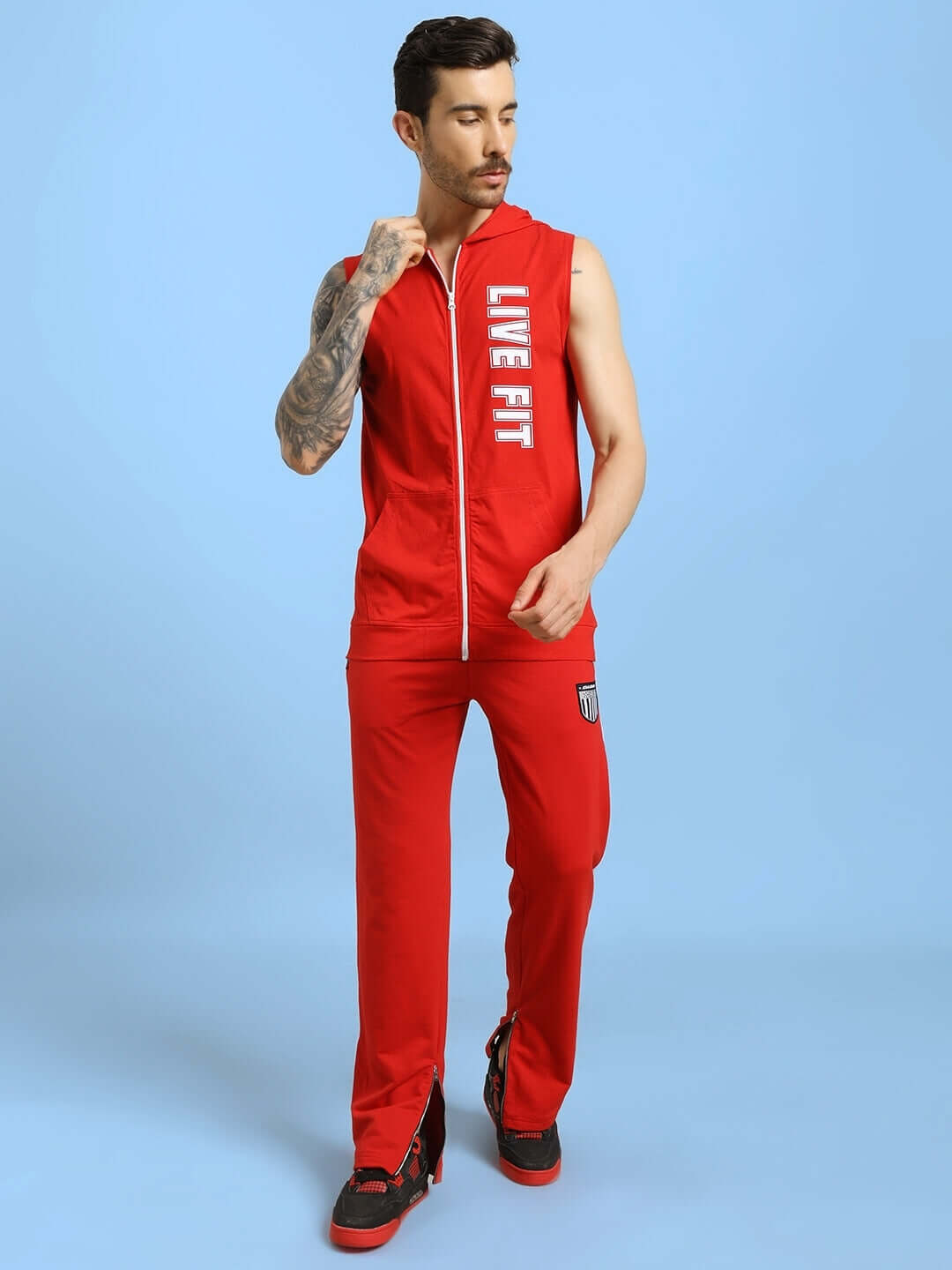 Model wearing DECENT LIVE FIT red hooded gym T-shirt showcasing front view.