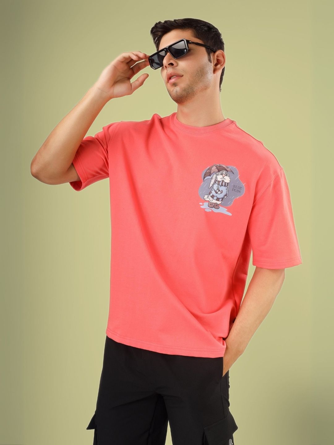 Man wearing BLUE LAPIN OVER-SIZED T-SHIRT PANTONE PEACH with graphic design