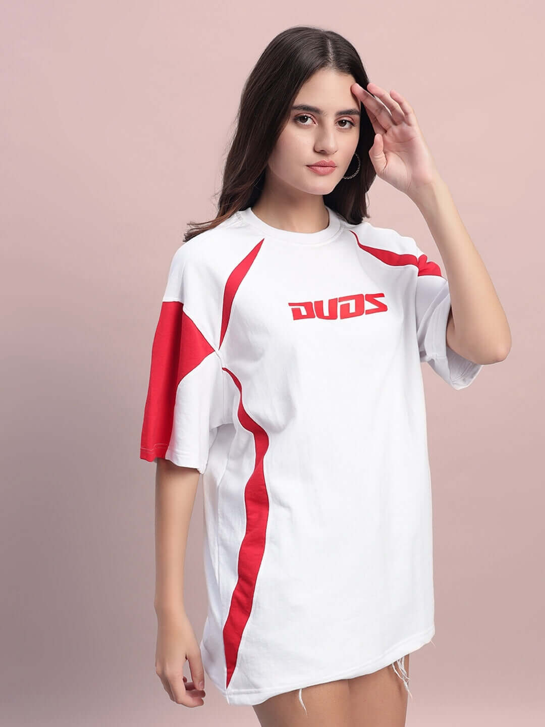 Woman wearing oversized white and red t-shirt made of premium cotton French terry with logos, ideal for a casual, stylish look.