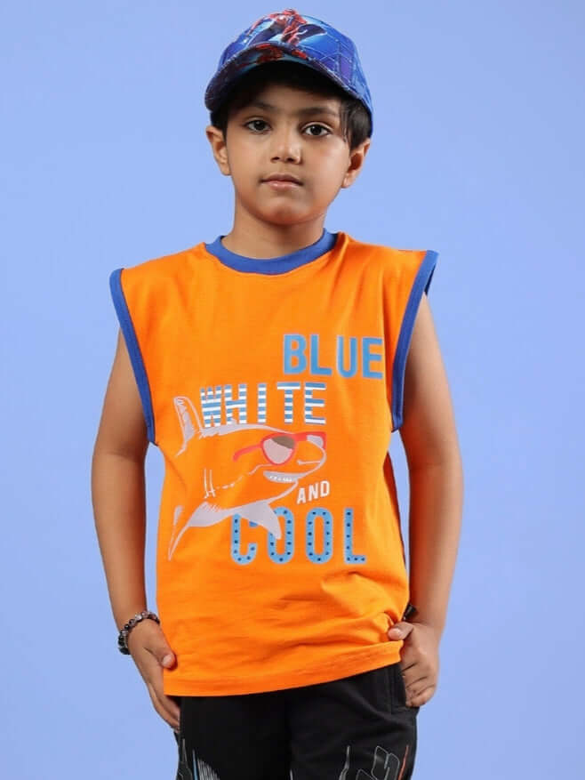 Child wearing Buffy T-shirt for Boys & Girls in orange, showcasing "Blue, White, and Cool" text with a shark design.