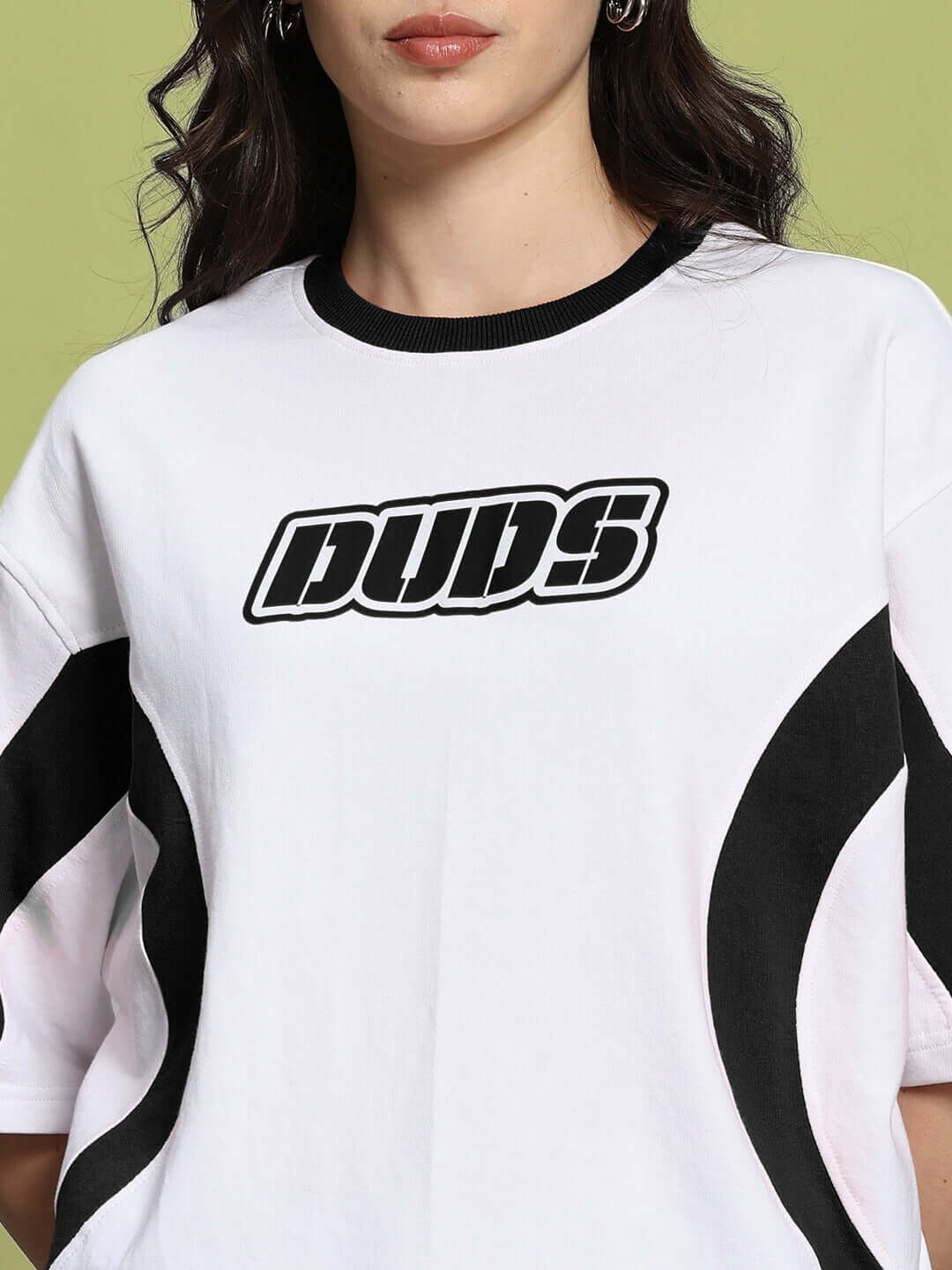 Women's oversized white-black T-shirt with 'DUDS' logo, premium cotton blend, showcasing casual style and comfort.