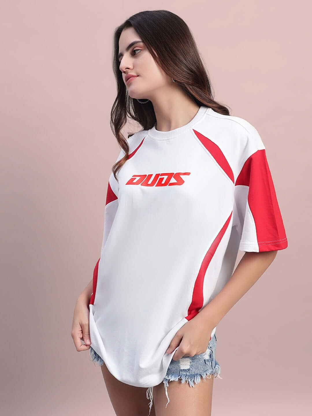 Model wearing a women's oversized white and red candor t-shirt in premium heavy gauge fabric, featuring cotton French terry and elastane.